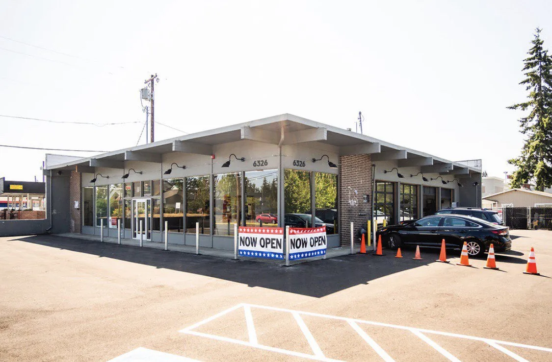Wide Lynnwood exterior and glass-front reception with parking area.