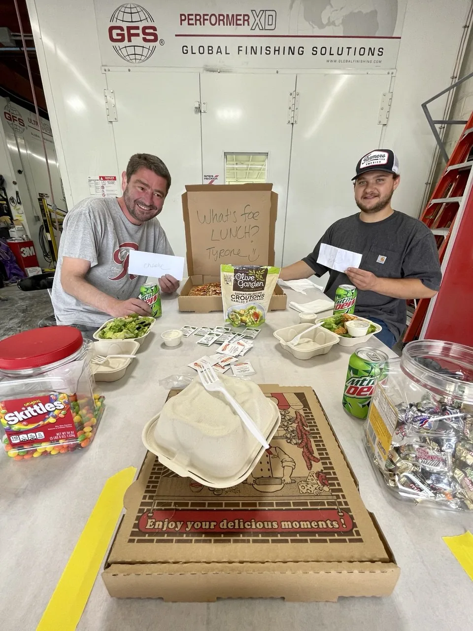Two team members at a lunch table.