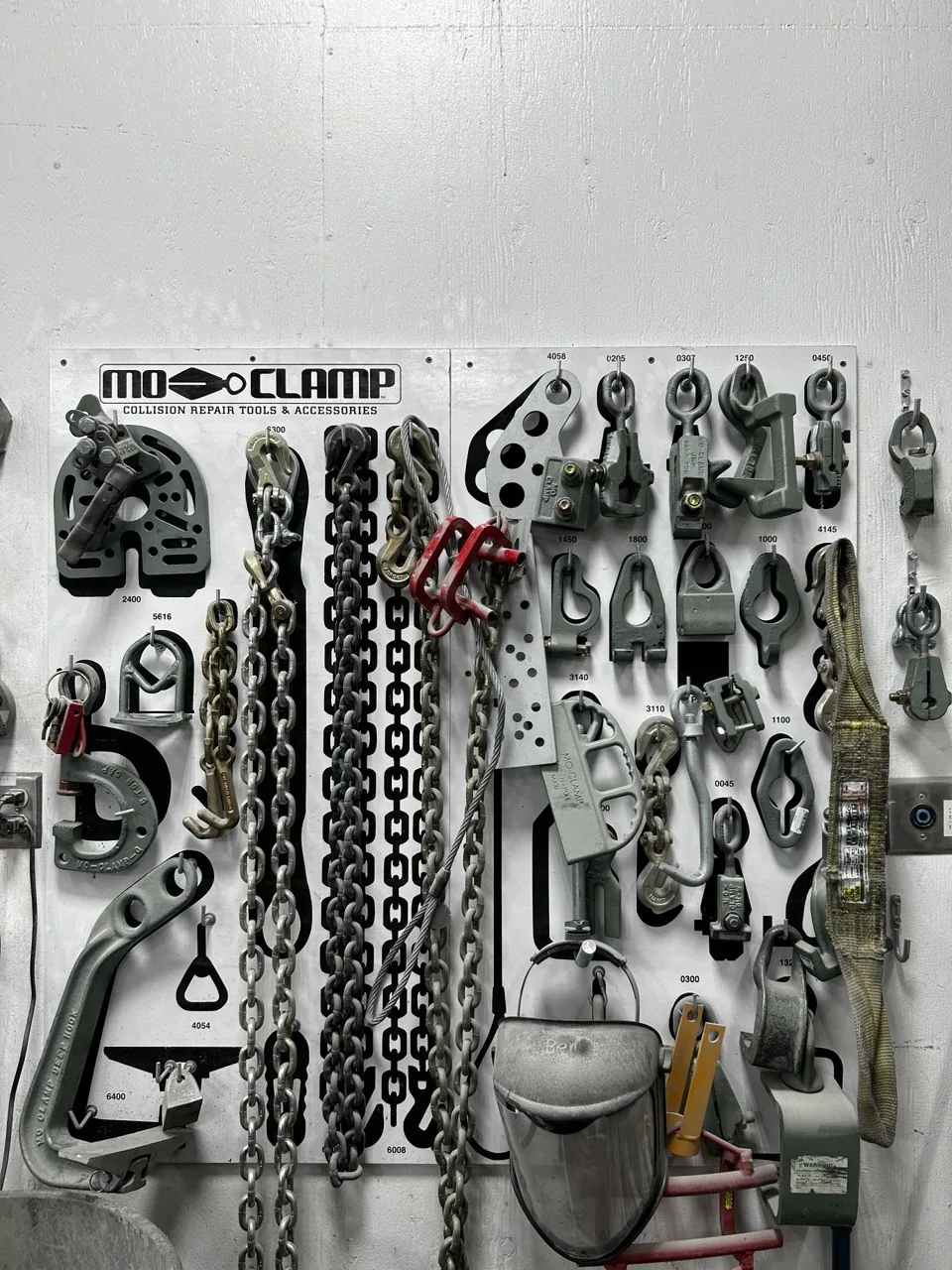 Mo-Clamp tools, clamps and chains on display board.